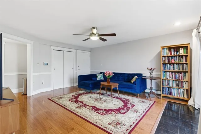 a living room with furniture and a book shelf