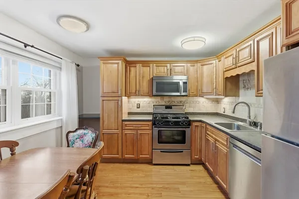 a kitchen with stainless steel appliances granite countertop a stove microwave and sink