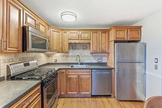 a kitchen with a stove a sink and a refrigerator