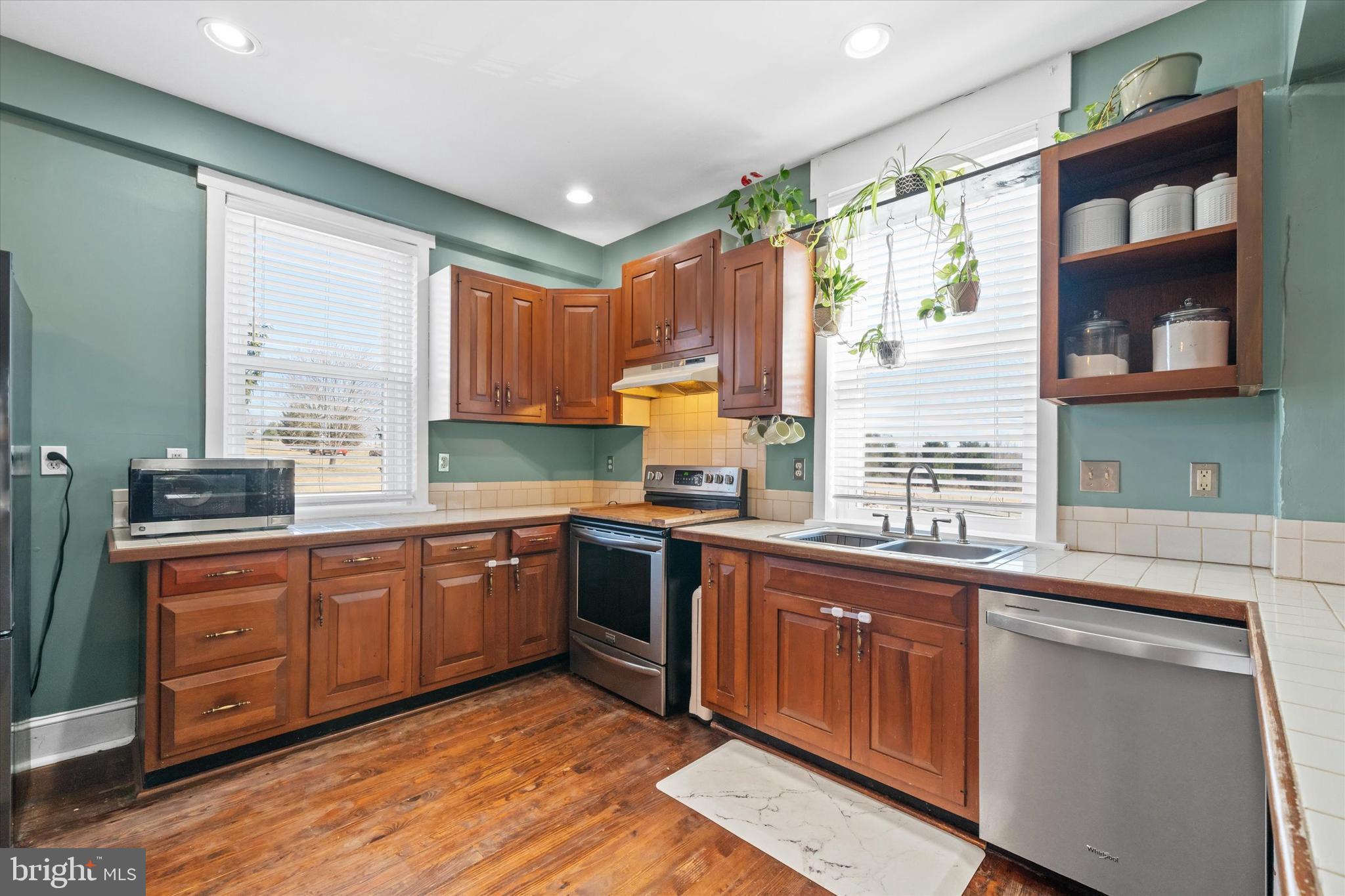 1647 Principio Furnace Road Perryville, MD 21903 - Photo 25 of 48 a kitchen with stainless steel appliances granite countertop wooden cabinets sink and window