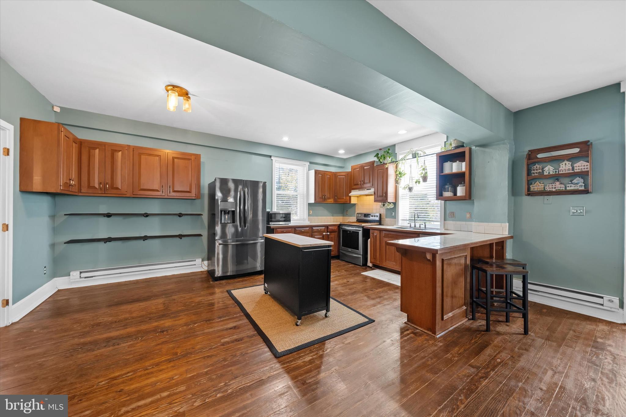 1647 Principio Furnace Road Perryville, MD 21903 - Photo 29 of 48 a kitchen with stainless steel appliances kitchen island granite countertop dining table chairs and a refrigerator