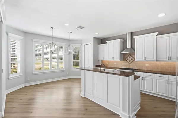 a kitchen with granite countertop a sink and cabinets