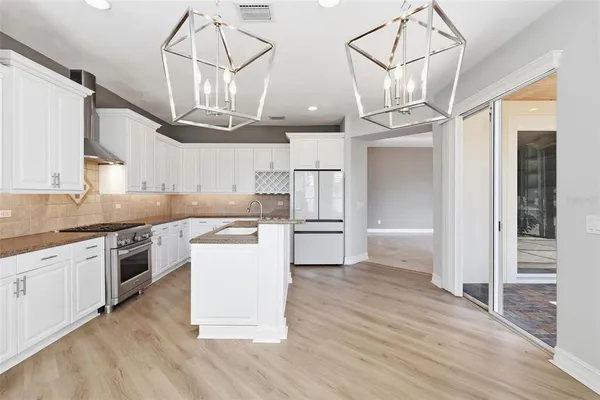 a kitchen with granite countertop a stove and a sink