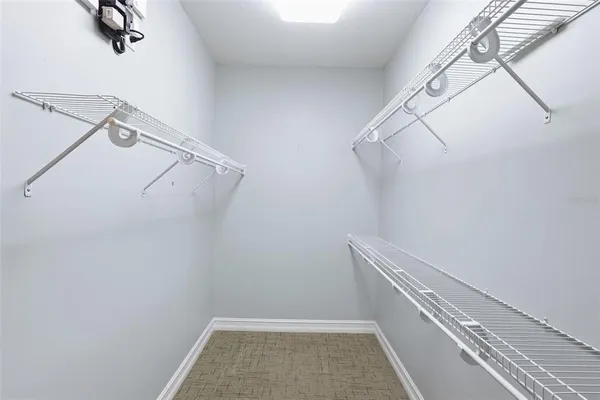 a view of walk in closet with empty racks