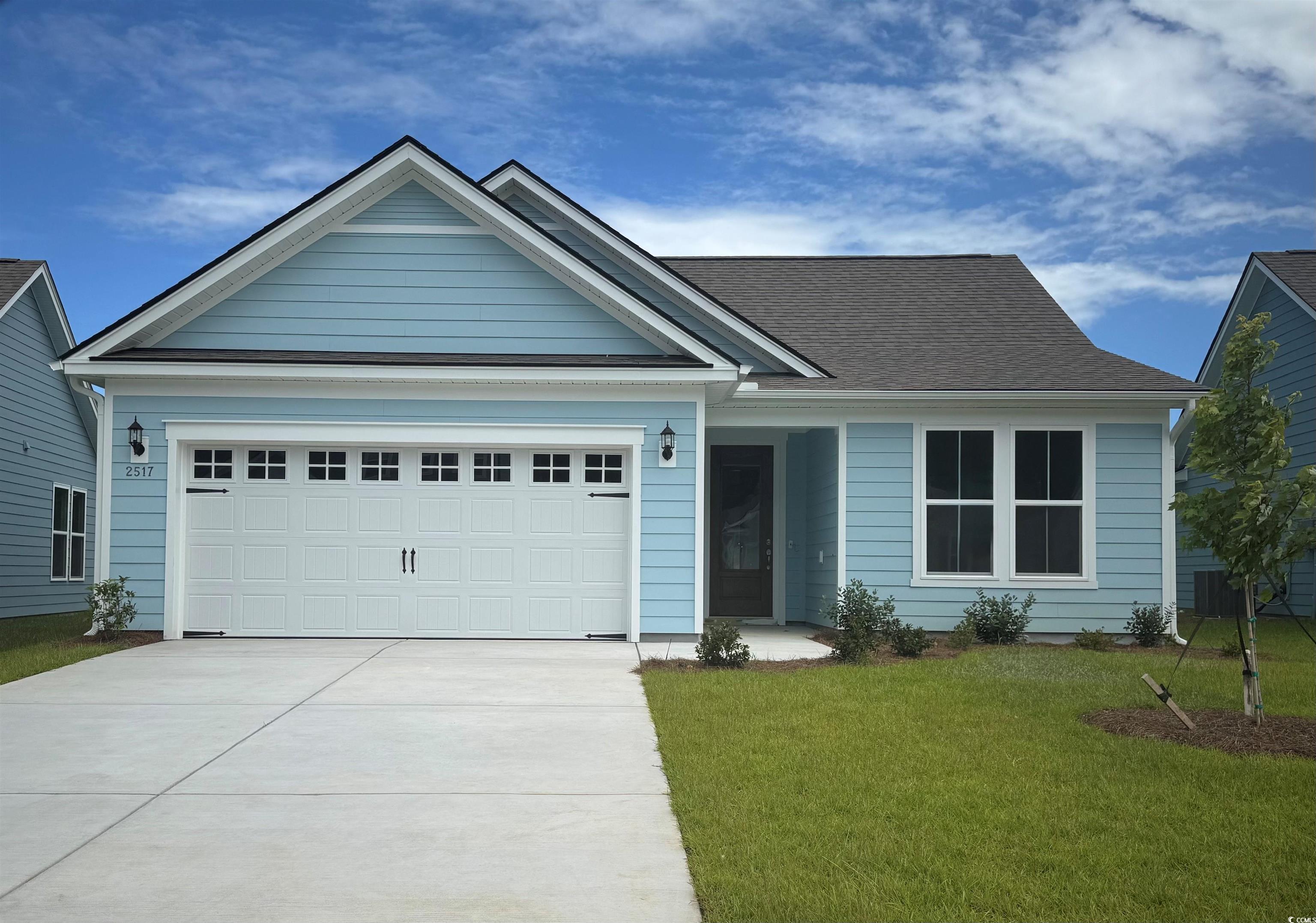 2517 Watershed Way Longs, SC 29568 - Photo 1 of 8 Ranch-style home with concrete driveway, a front yard, and a garage