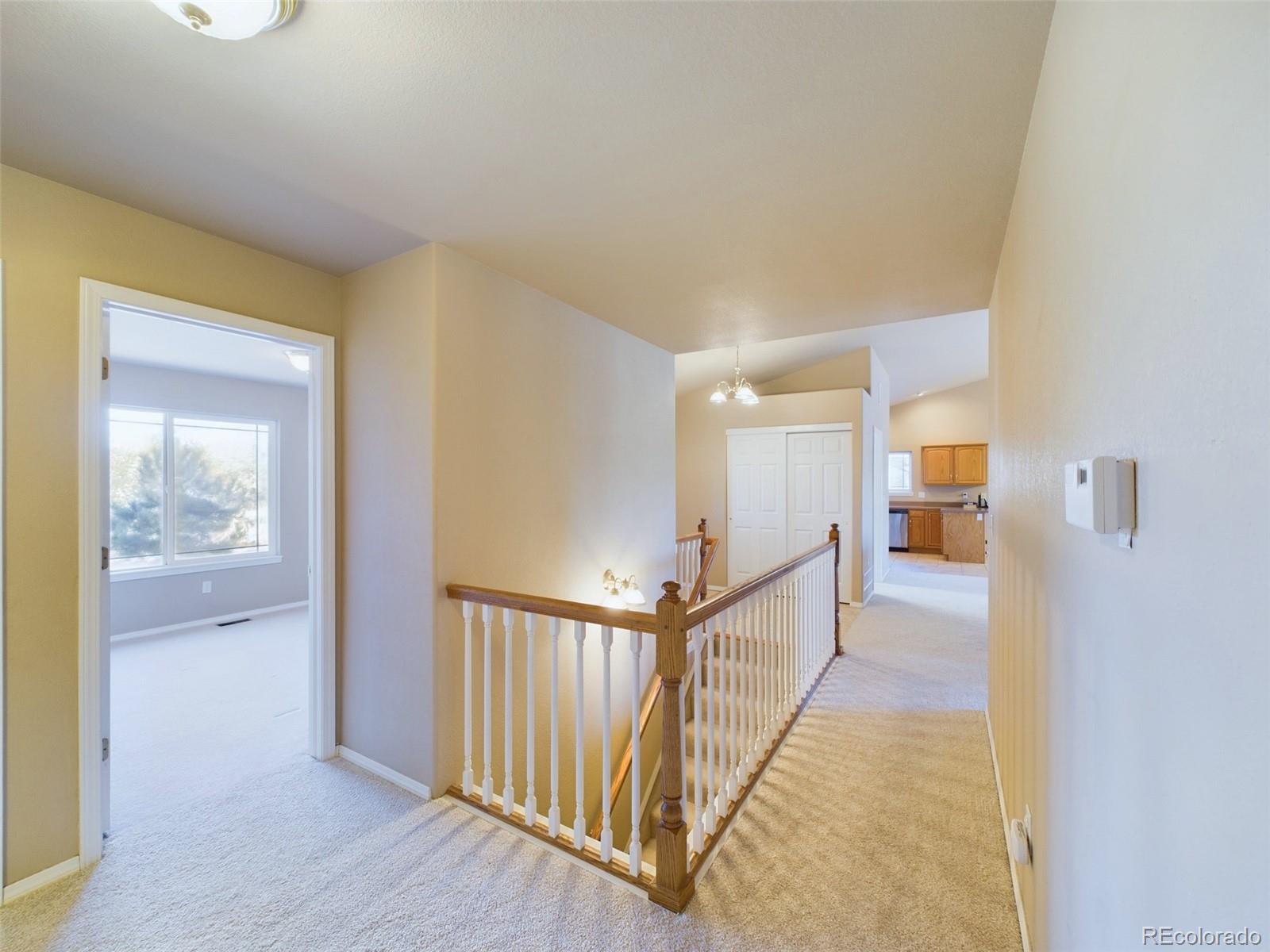 5140 Shoup Road Colorado Springs, CO 80908 - Photo 14 of 42 a view of a hallway with wooden floor and closet