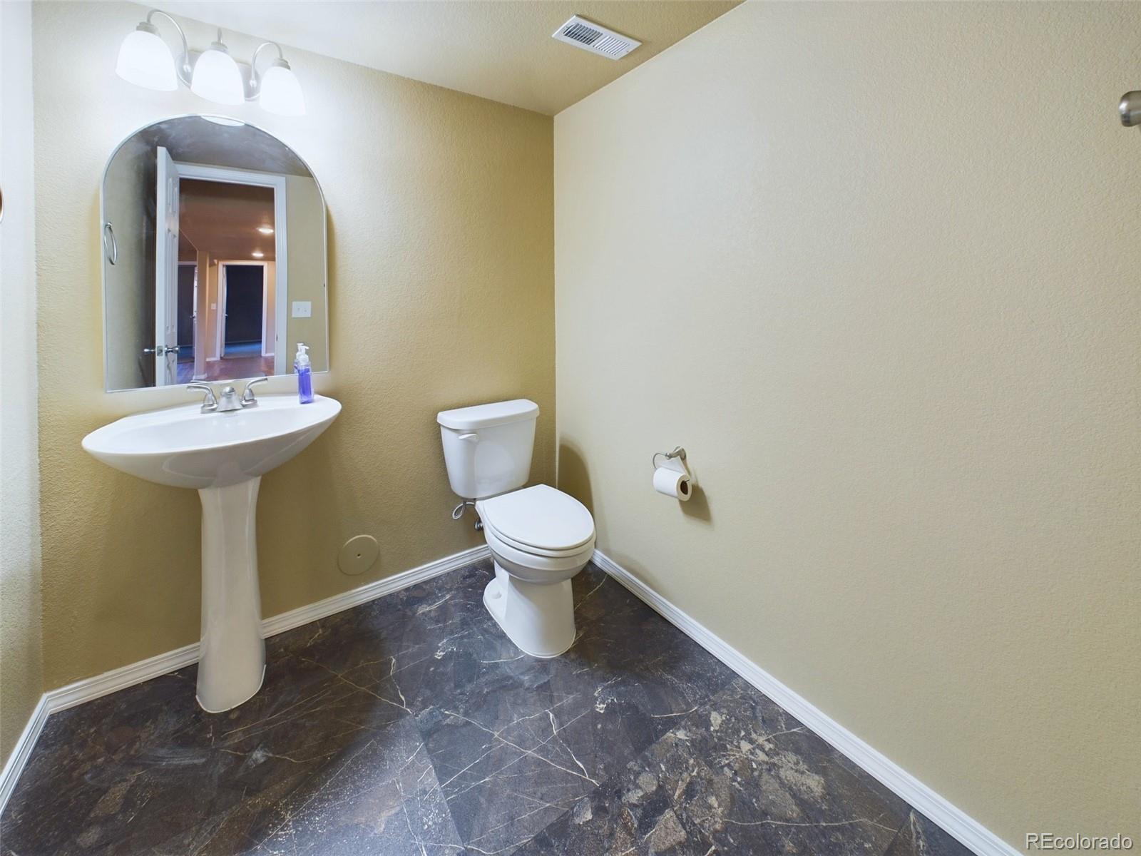 5140 Shoup Road Colorado Springs, CO 80908 - Photo 22 of 42 a bathroom with a toilet sink and mirror