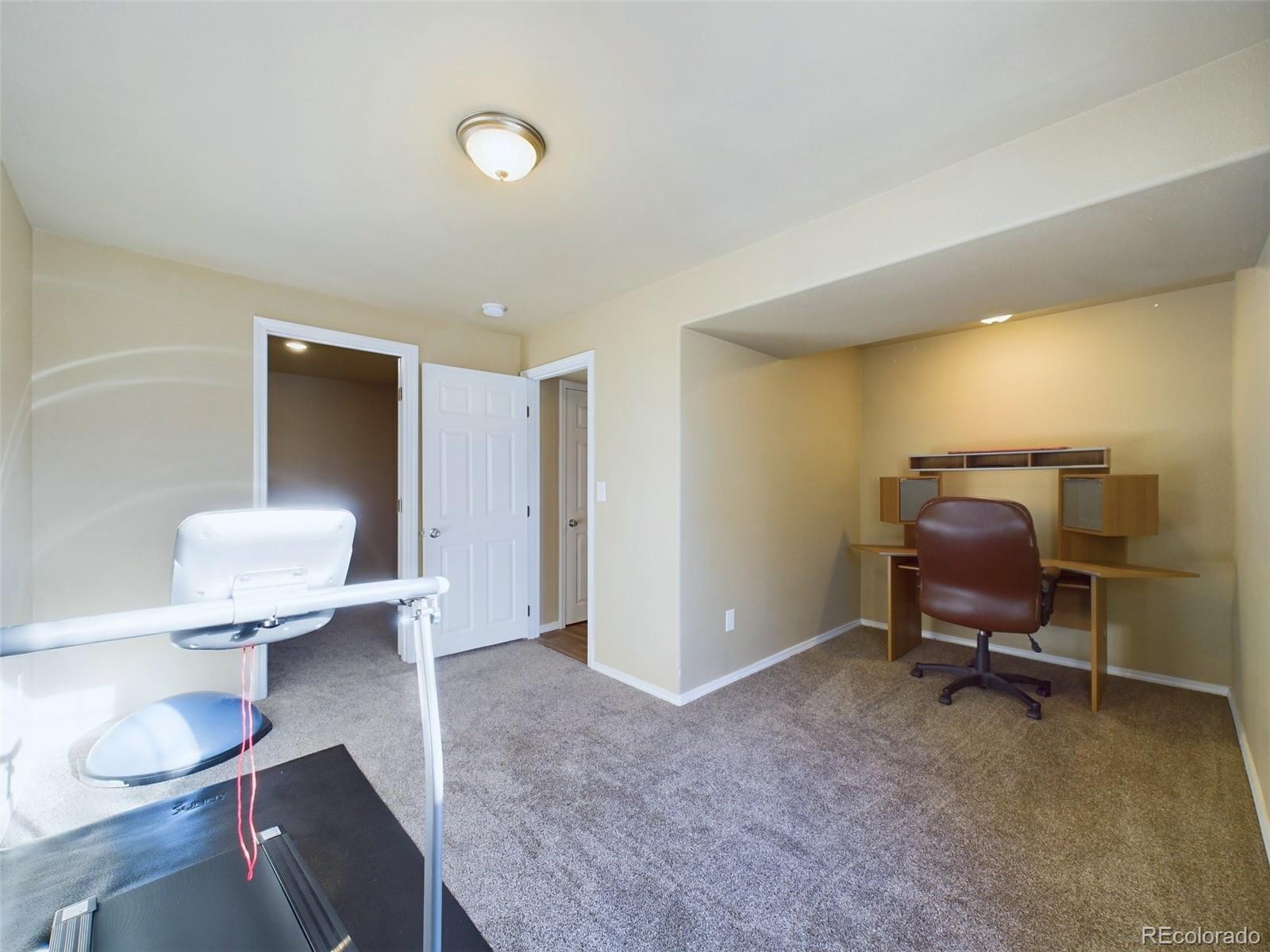 5140 Shoup Road Colorado Springs, CO 80908 - Photo 23 of 42 a living room with furniture and a lamp