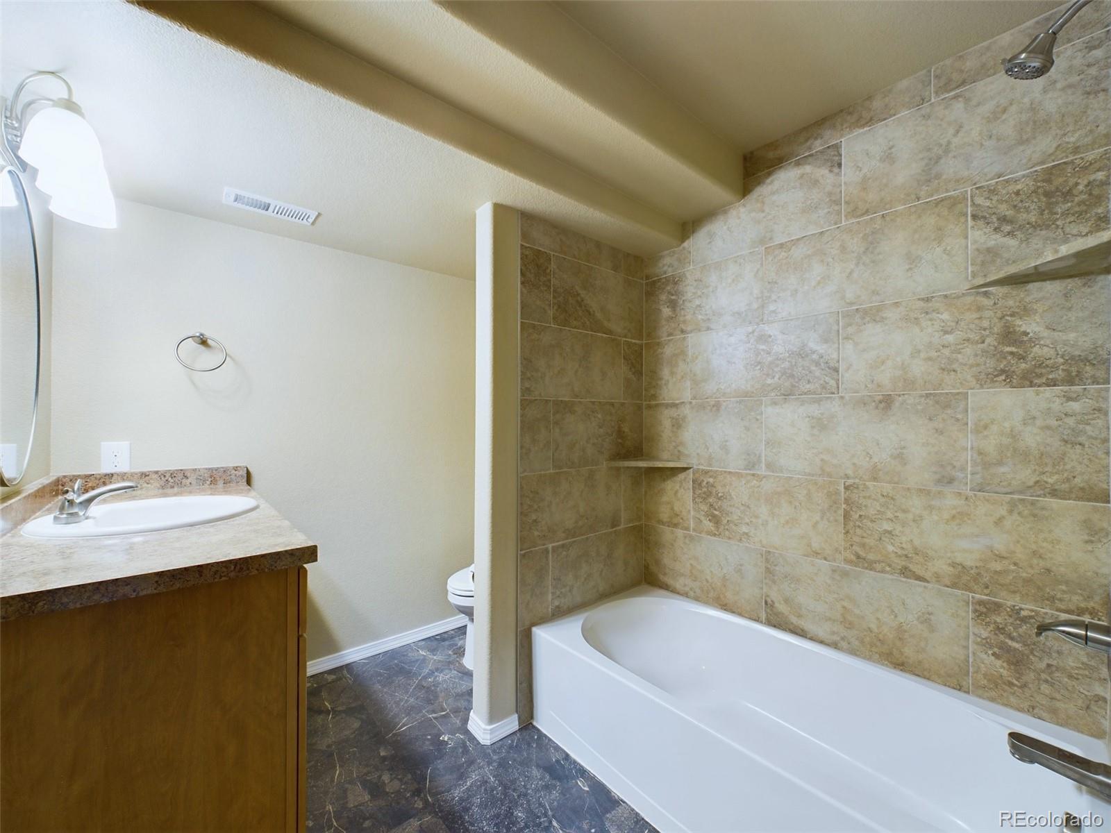5140 Shoup Road Colorado Springs, CO 80908 - Photo 24 of 42 a bathroom with a sink a bathtub and a shower