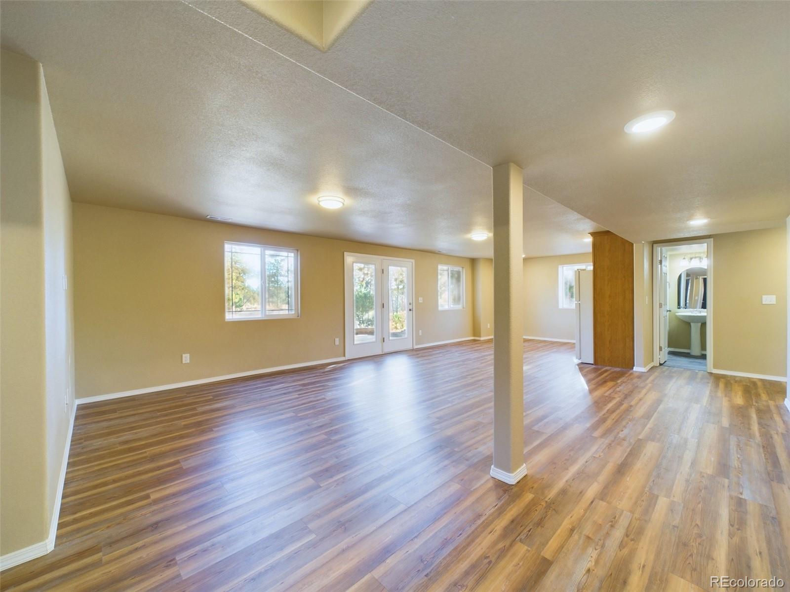 5140 Shoup Road Colorado Springs, CO 80908 - Photo 25 of 42 a view of an empty room with wooden floor and a window