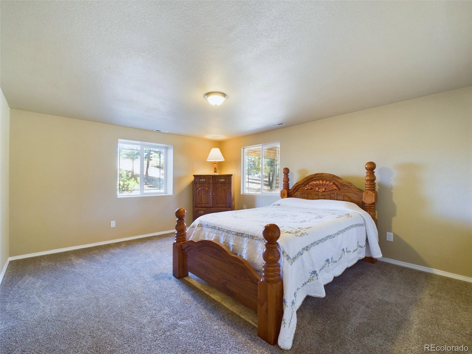 5140 Shoup Road Colorado Springs, CO 80908 - Photo 26 of 42 a bedroom with a bed and a window