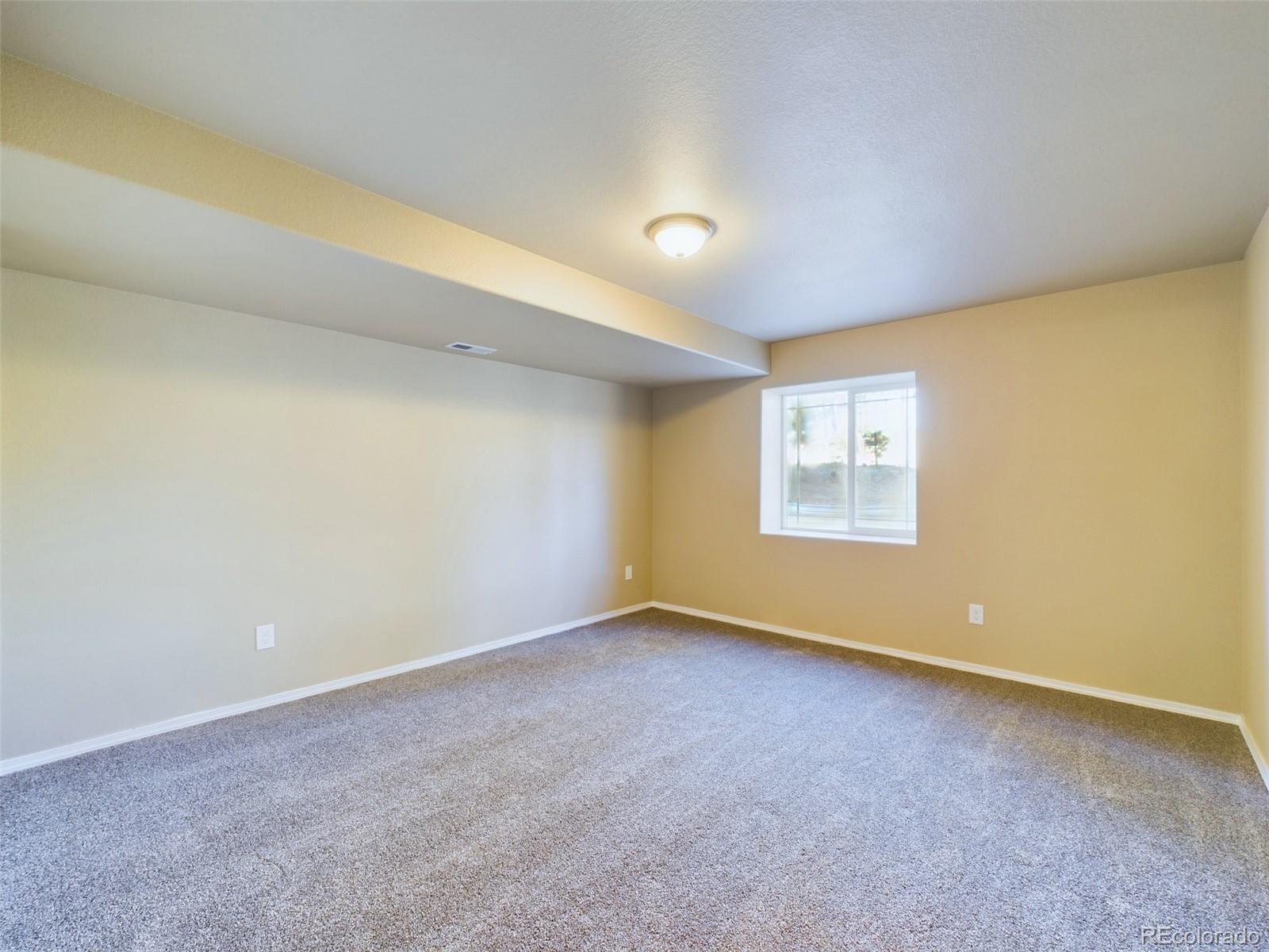 5140 Shoup Road Colorado Springs, CO 80908 - Photo 27 of 42 a view of an empty room with a window