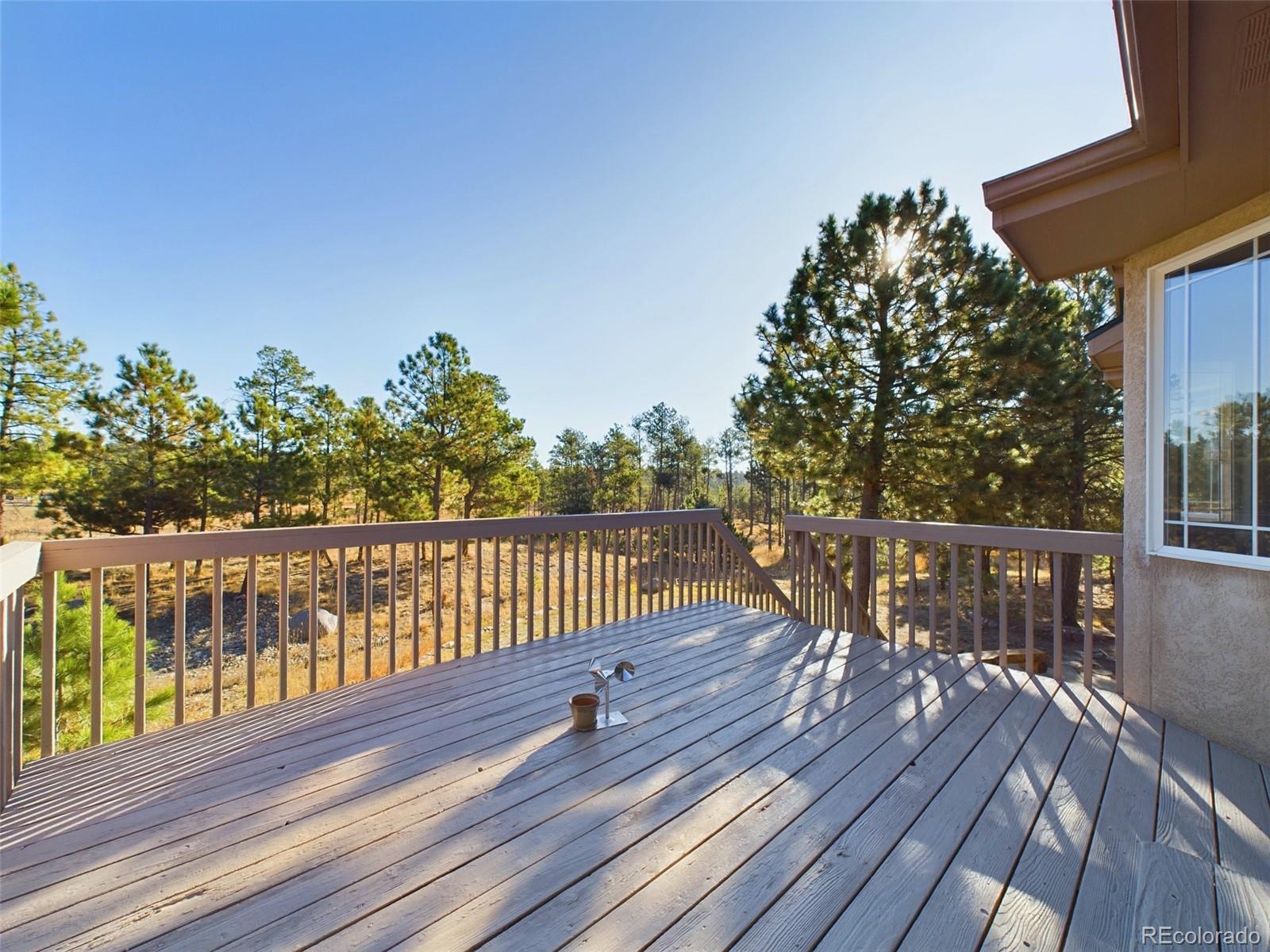 5140 Shoup Road Colorado Springs, CO 80908 - Photo 31 of 42 a view of balcony with wooden floor and fence