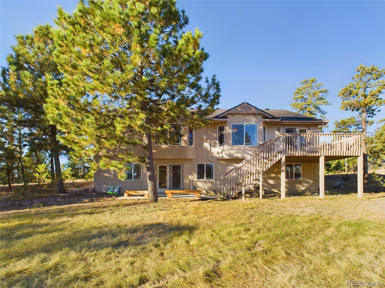 5140 Shoup Road Colorado Springs, CO 80908 - Photo 33 of 42 a front view of a house with a tree in it