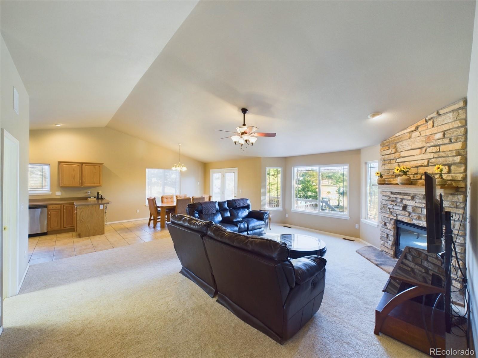 5140 Shoup Road Colorado Springs, CO 80908 - Photo 4 of 42 a living room with furniture fireplace and flat screen tv