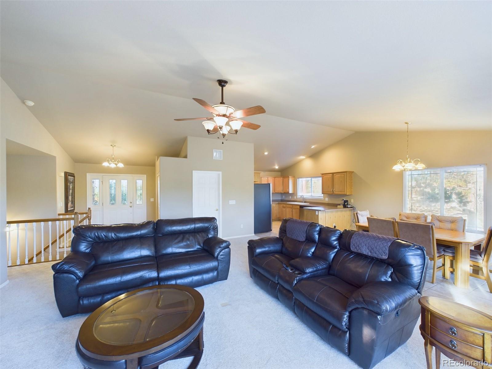 5140 Shoup Road Colorado Springs, CO 80908 - Photo 5 of 42 a living room with a couch and chandelier