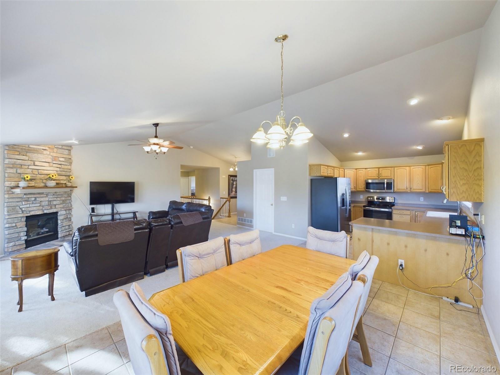 5140 Shoup Road Colorado Springs, CO 80908 - Photo 6 of 42 a view of a dining room and livingroom with furniture wooden floor a chandelier