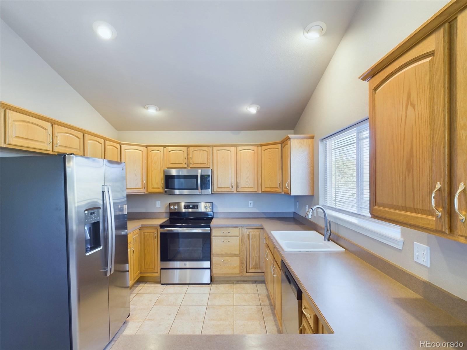 5140 Shoup Road Colorado Springs, CO 80908 - Photo 7 of 42 a kitchen with refrigerator and window