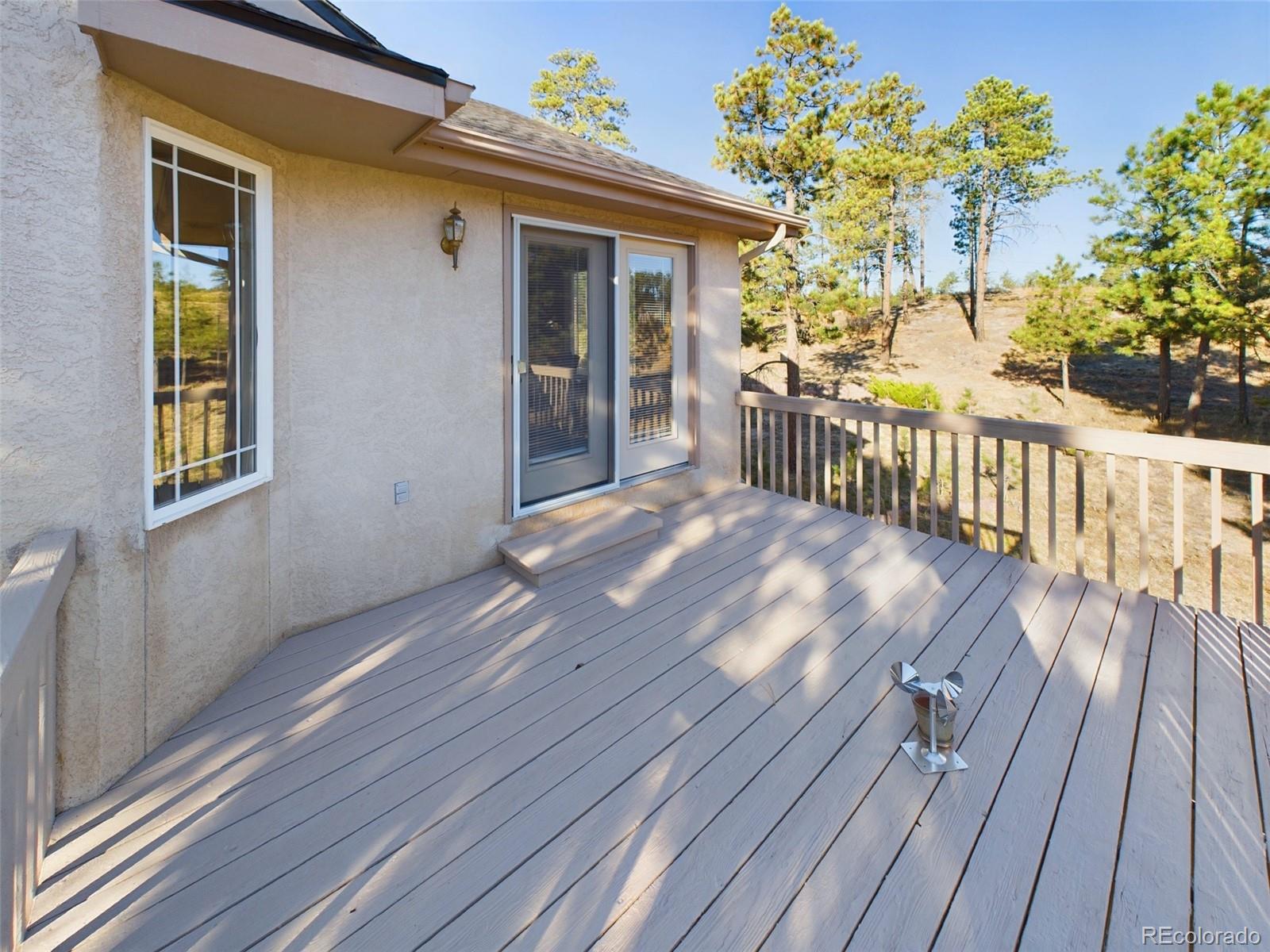 5140 Shoup Road Colorado Springs, CO 80908 - Photo 8 of 42 a view of backyard with a deck and wooden floor