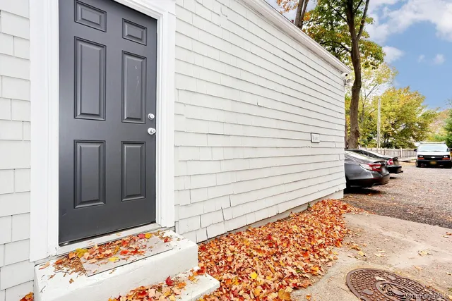 a view of a hallway with wooden floor and a livingroom view