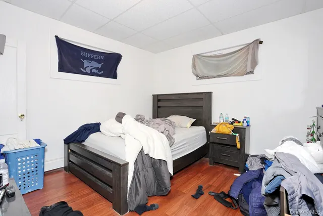 a bedroom with bed and a flat screen tv