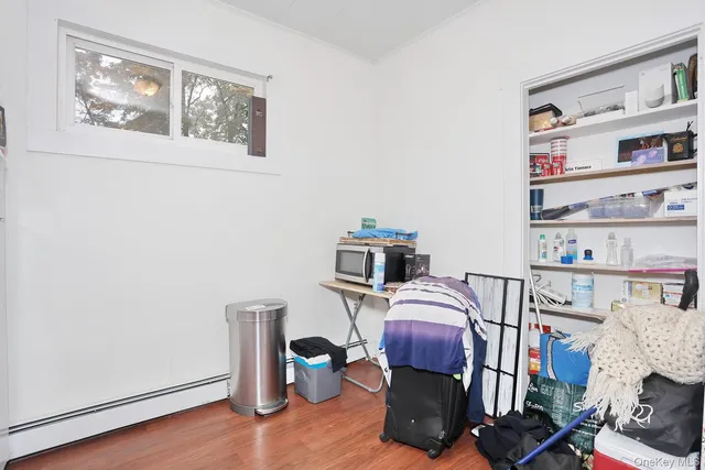 a kitchen with white cabinets and appliances