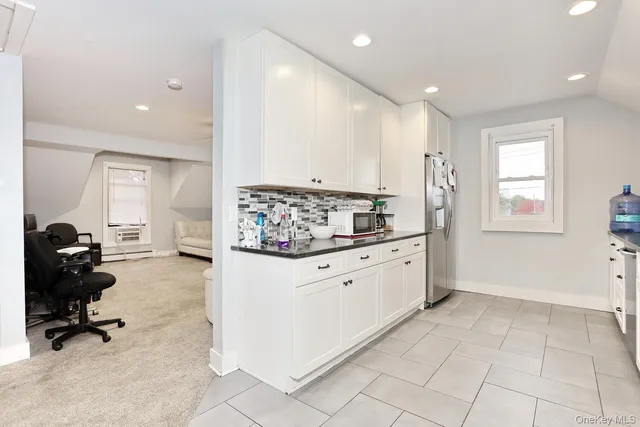 a kitchen with stainless steel appliances kitchen island granite countertop a sink and cabinets