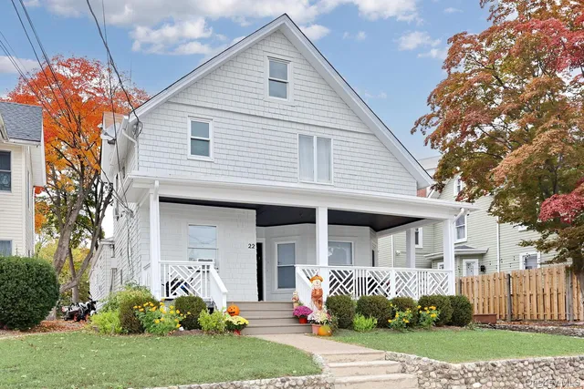 a front view of a house with a yard and porch