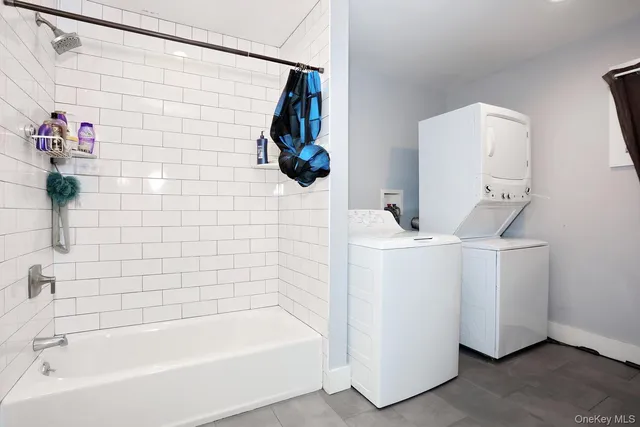 a bathroom with a bathtub sink and mirror