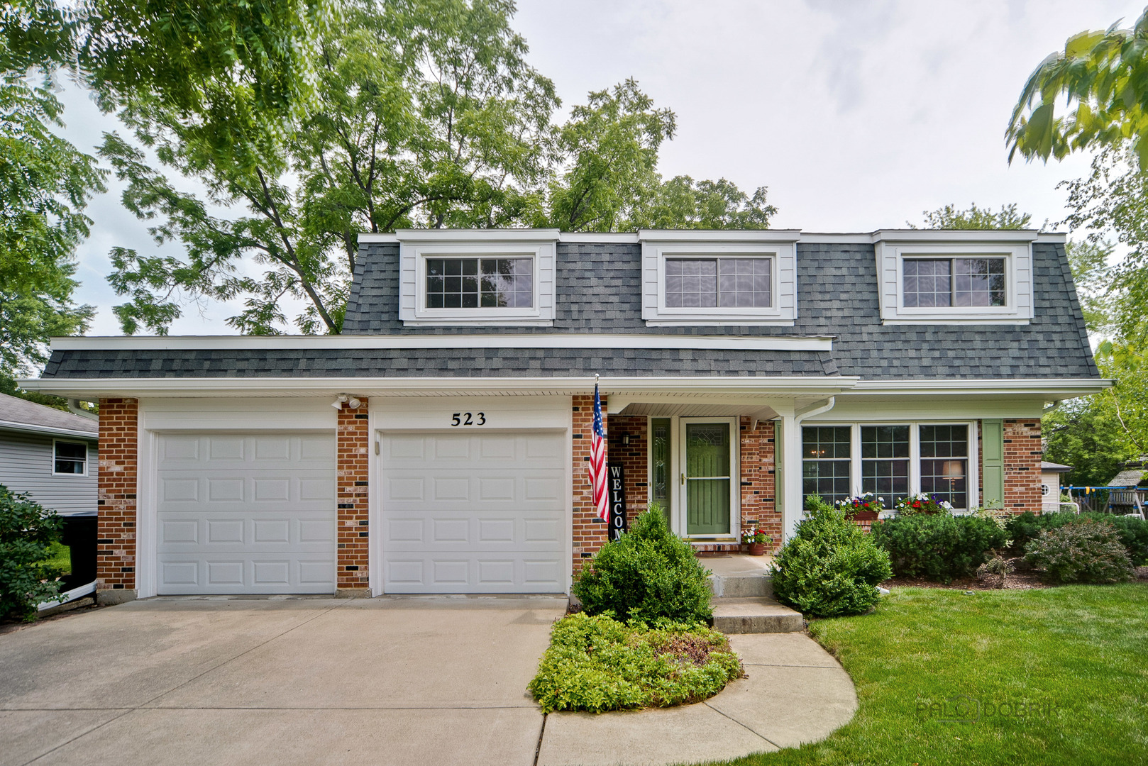 523 Northgate Road Lindenhurst, IL 60046 - Photo 1 of 1 a front view of a house with a yard and garage