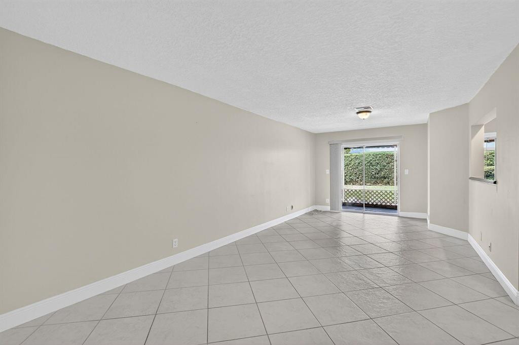 5051 Pointe Emerald Lane, Unit 5051 Boca Raton, FL 33431 - Photo 18 of 65 an empty room with windows
