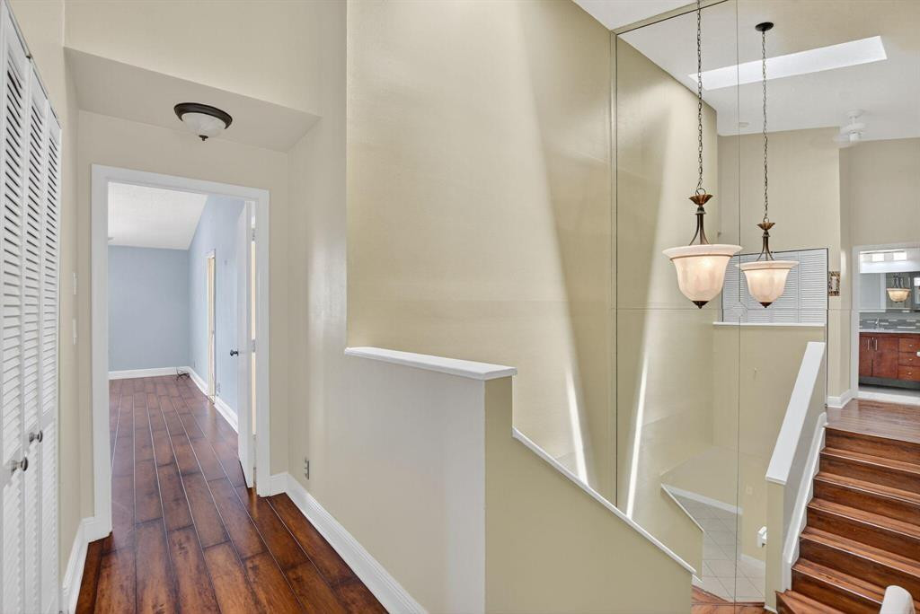 5051 Pointe Emerald Lane, Unit 5051 Boca Raton, FL 33431 - Photo 20 of 65 a view of a hallway with wooden floor and staircase