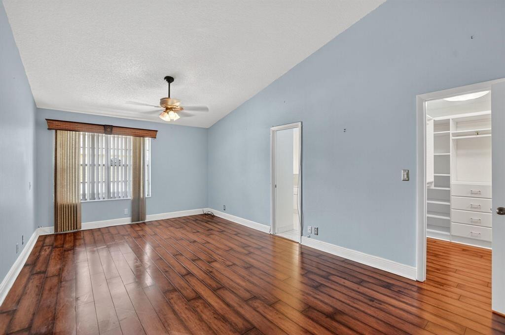 5051 Pointe Emerald Lane, Unit 5051 Boca Raton, FL 33431 - Photo 22 of 65 wooden floor in an empty room with a window