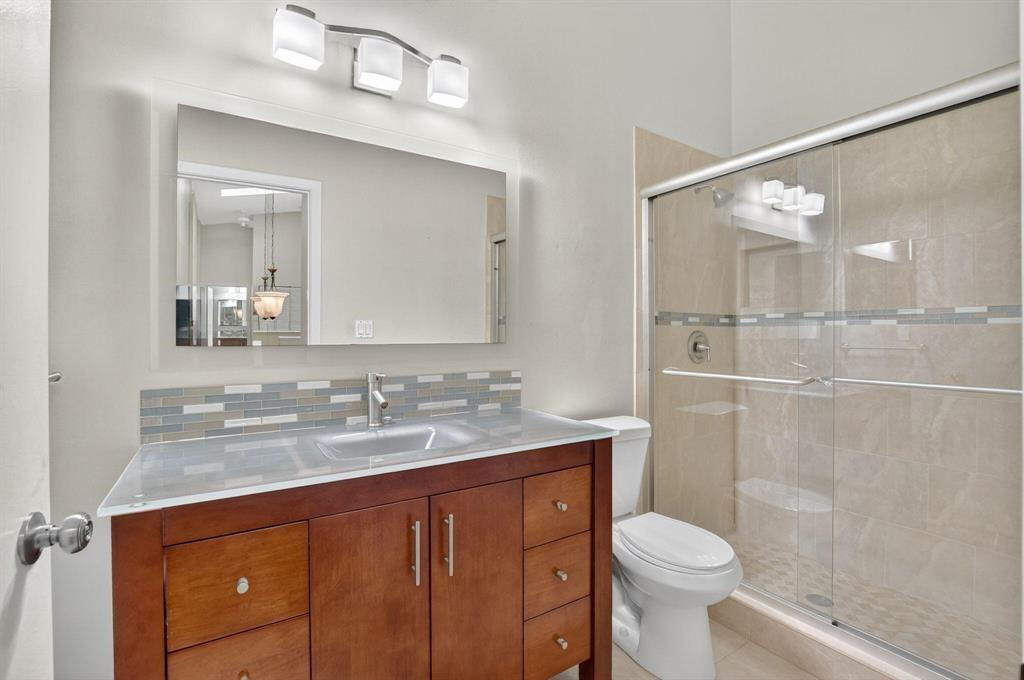 5051 Pointe Emerald Lane, Unit 5051 Boca Raton, FL 33431 - Photo 32 of 65 a bathroom with a sink vanity granite toilet and shower