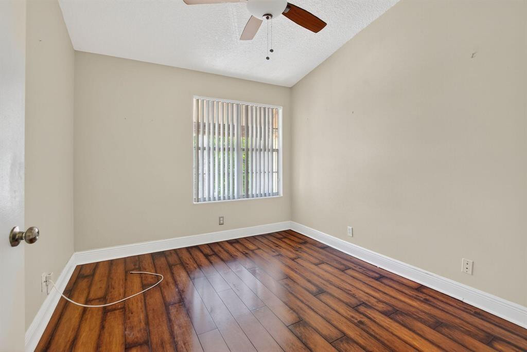 5051 Pointe Emerald Lane, Unit 5051 Boca Raton, FL 33431 - Photo 34 of 65 wooden floor in an empty room with a window