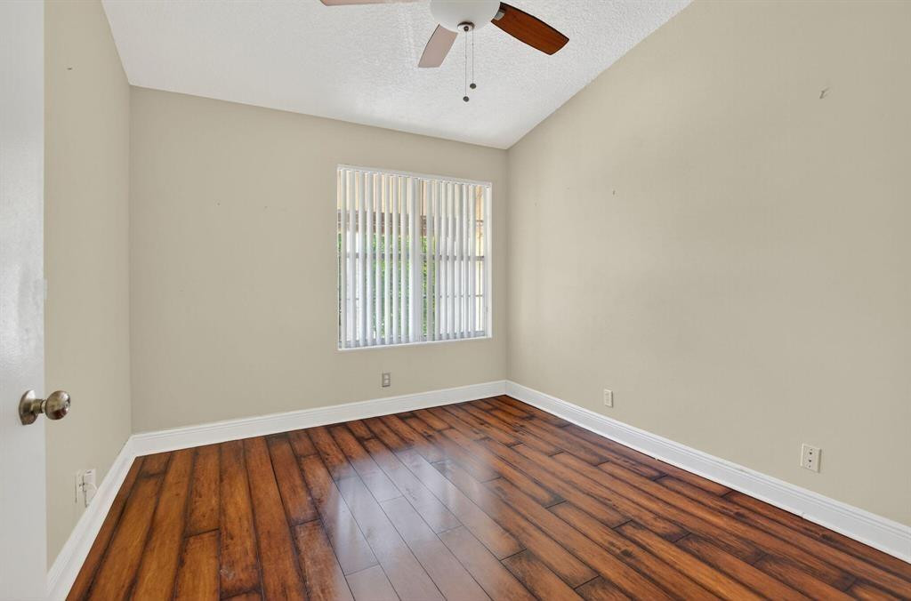 5051 Pointe Emerald Lane, Unit 5051 Boca Raton, FL 33431 - Photo 35 of 65 wooden floor in an empty room with a window