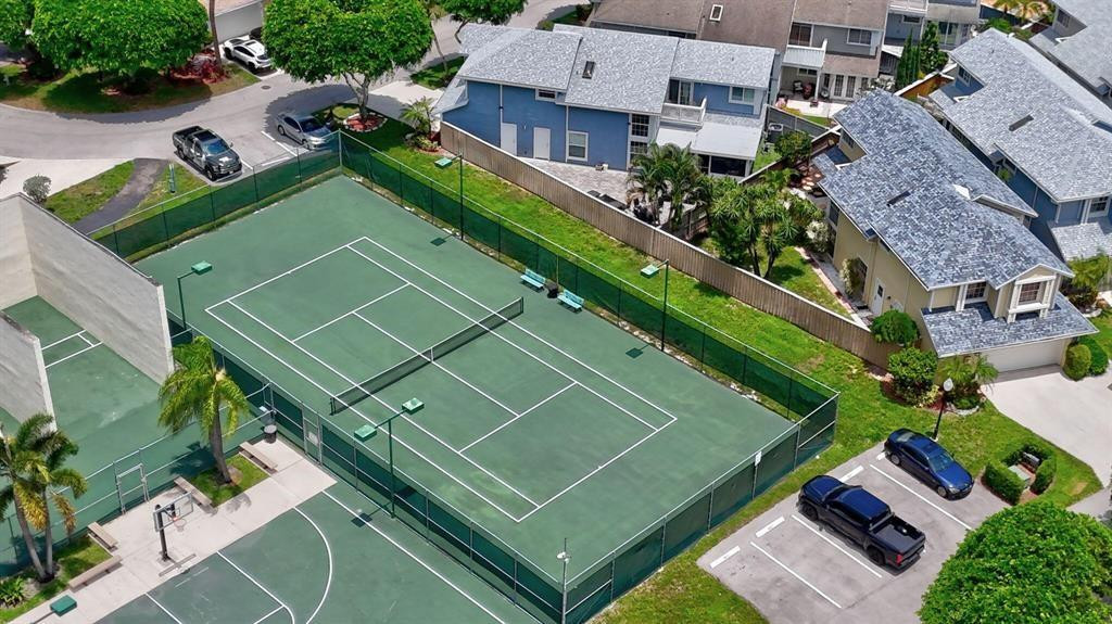 5051 Pointe Emerald Lane, Unit 5051 Boca Raton, FL 33431 - Photo 4 of 65 an aerial view of a tennis ground and a cars park