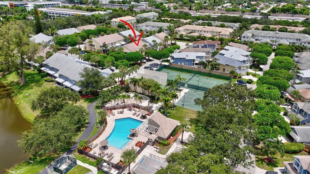 5051 Pointe Emerald Lane, Unit 5051 Boca Raton, FL 33431 - Photo 48 of 65 an aerial view of a house with a yard and lake view