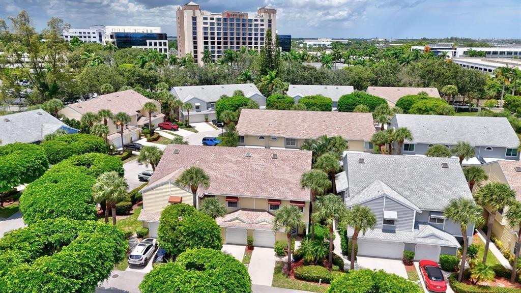 5051 Pointe Emerald Lane, Unit 5051 Boca Raton, FL 33431 - Photo 51 of 65 an aerial view of multiple houses with yard