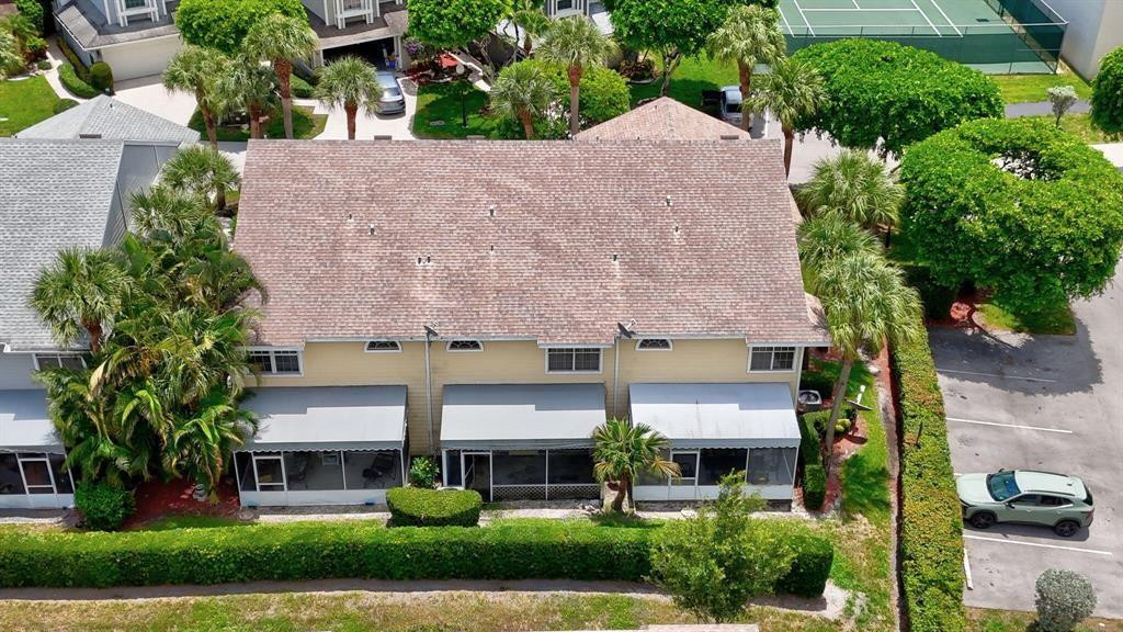 5051 Pointe Emerald Lane, Unit 5051 Boca Raton, FL 33431 - Photo 58 of 65 front view of a house with a yard and potted plants