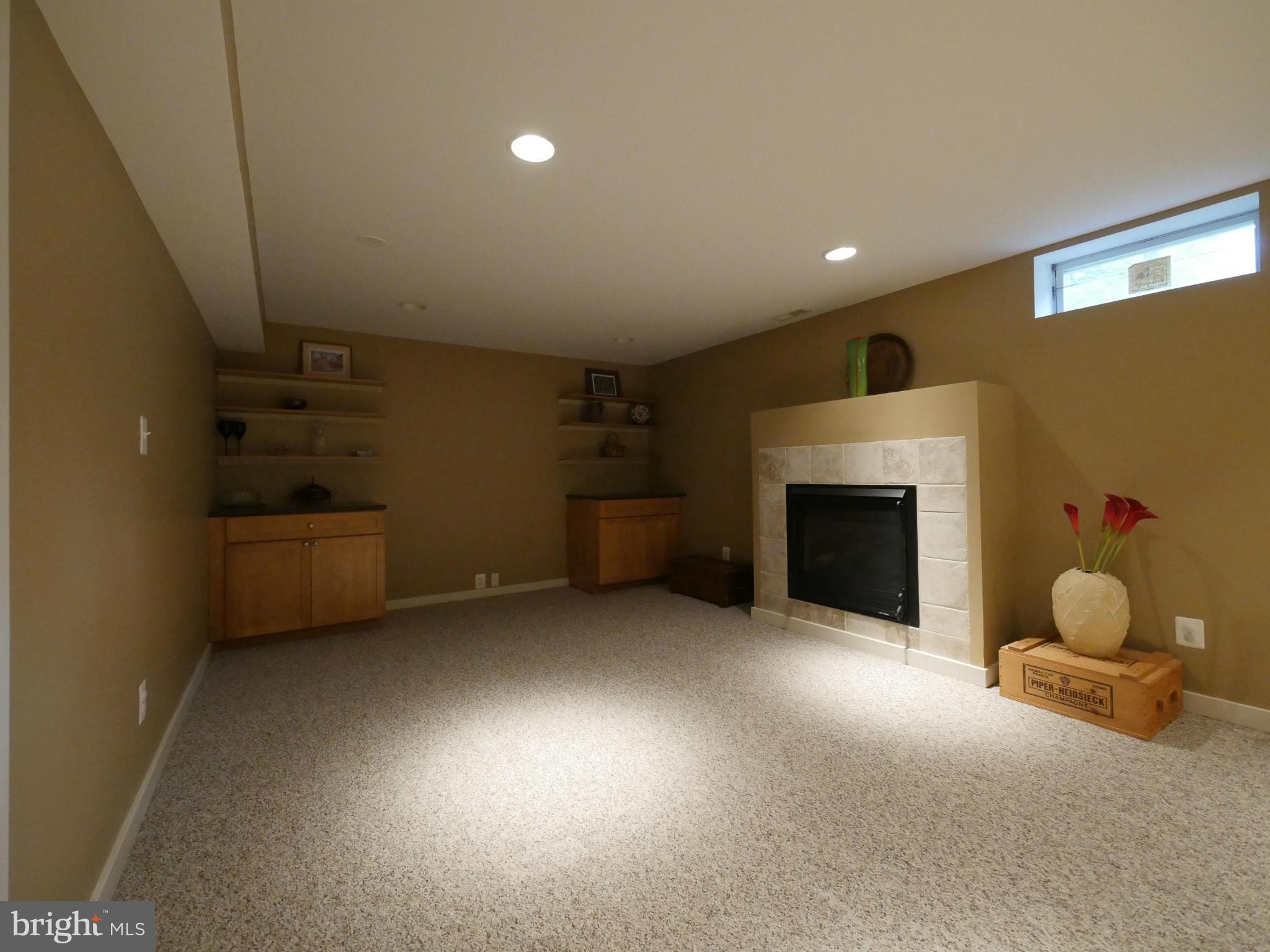 7360 Kindler Road Columbia, MD 21046 - Photo 23 of 30 Basement TV area with 3rd gas fireplace