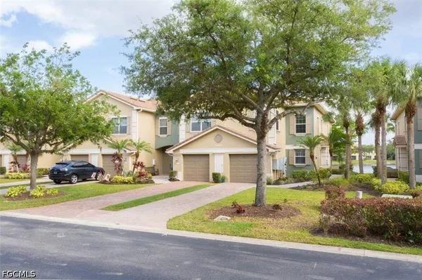 a front view of a house with a yard garage and outdoor seating