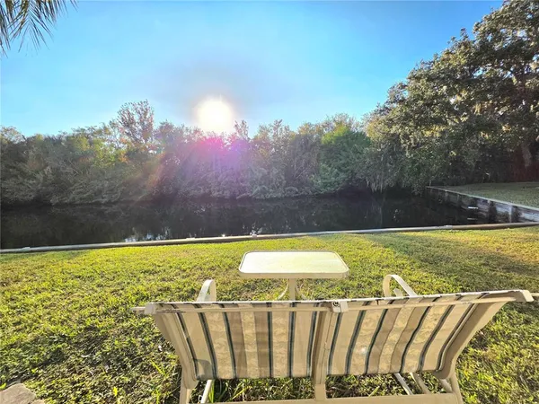 a view of a swimming pool with an outdoor seating and a yard