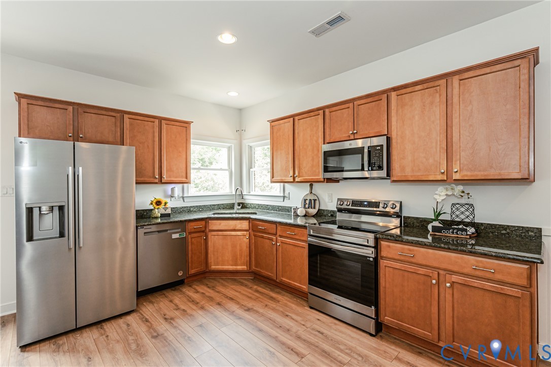 2018 Valentine Road Henrico, VA 23228 - Photo 44 of 65 a kitchen with granite countertop stainless steel appliances a sink cabinets and a window