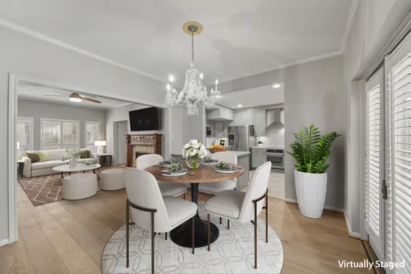 a view of a dining room with furniture and chandelier