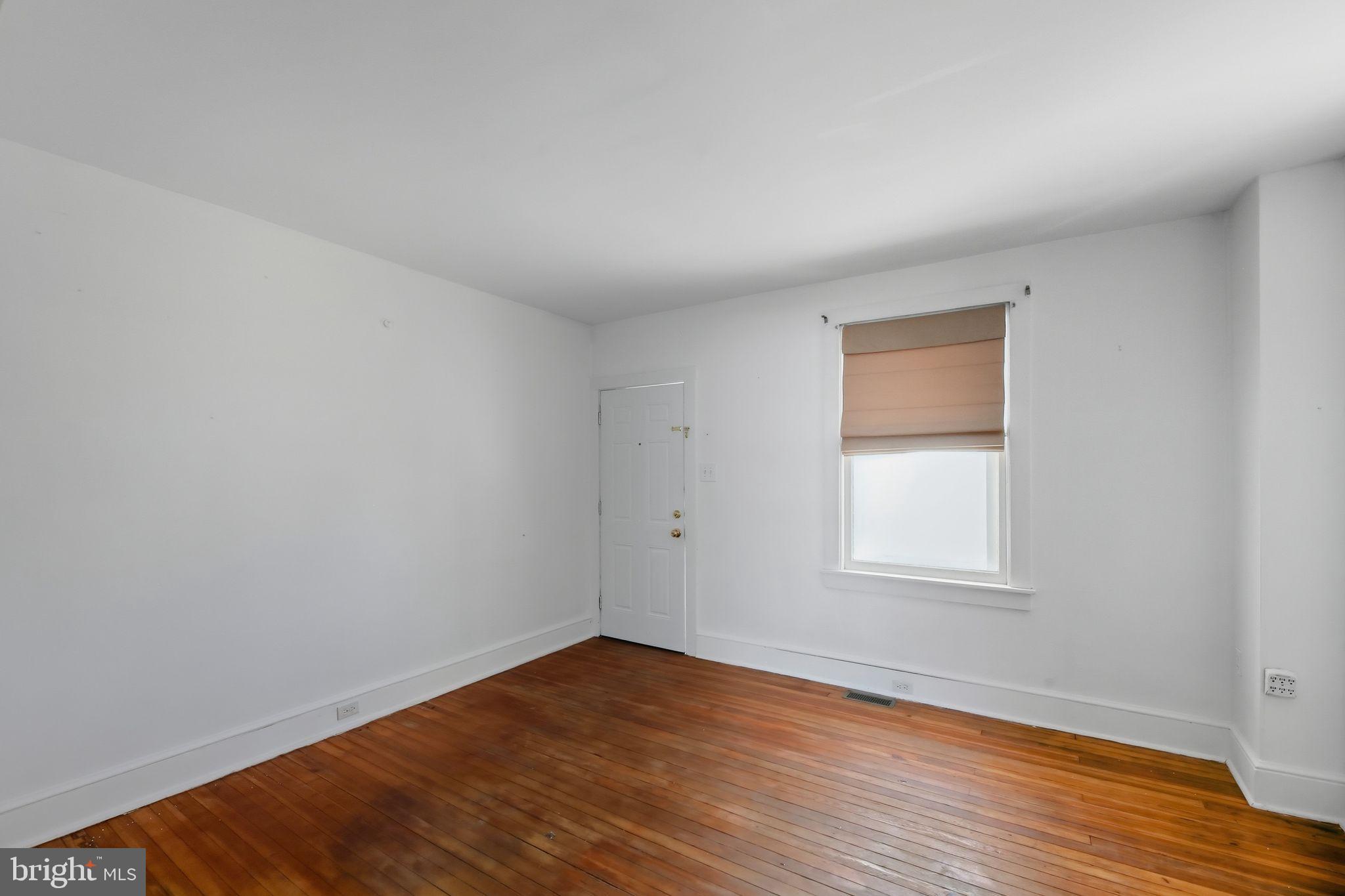 521 Bem Street Riverside, NJ 08075 - Photo 14 of 16 an empty room with wooden floor and windows