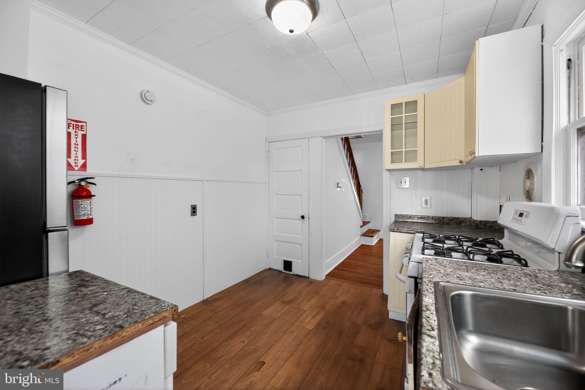 521 Bem Street Riverside, NJ 08075 - Photo 6 of 16 a kitchen with a stove and a refrigerator