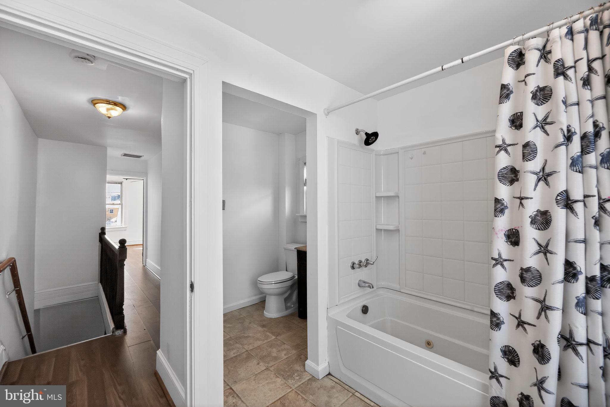 521 Bem Street Riverside, NJ 08075 - Photo 9 of 16 a bathroom with a bathtub and a shower