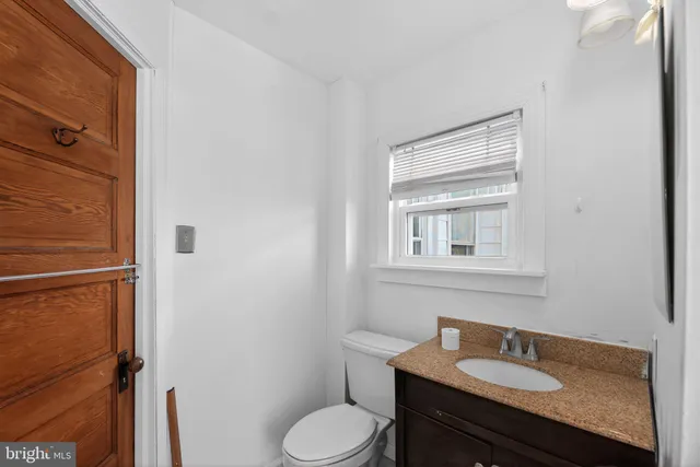 a bathroom with a sink toilet and vanity