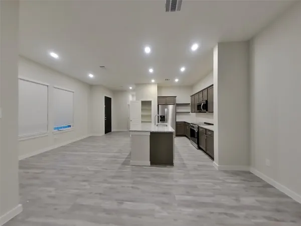 a view of a hallway with a refrigerator